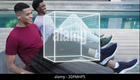 Relaxing two men wearing maroon tee and light top at poolside deck, with wireframe cube Stock Photo