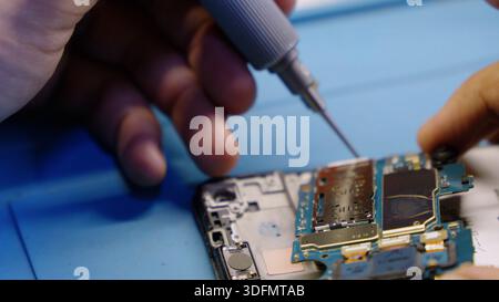 Soldering electronic components on phone Stock Photo