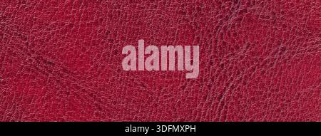 Dark red faux leather texture background with embossed reptile skin pattern. Structure of wine surface, macro. Stock Photo