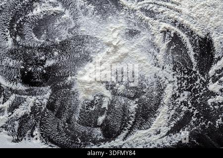 Flour Scattered Artfully on a Dark Kitchen Surface Creating Unique Patterns and Textures Stock Photo