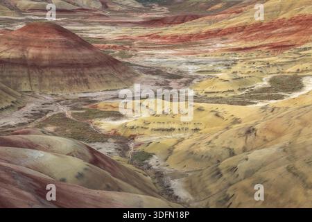 High angle view of multi-colored volcanic ash layers and claystone hills at Painted Hills, John Day Fossil Beds National Monument, Oregon, USA. Stock Photo