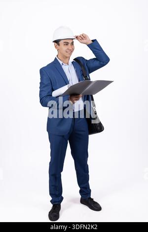 Businessman in hard hat with clipboard Stock Photo