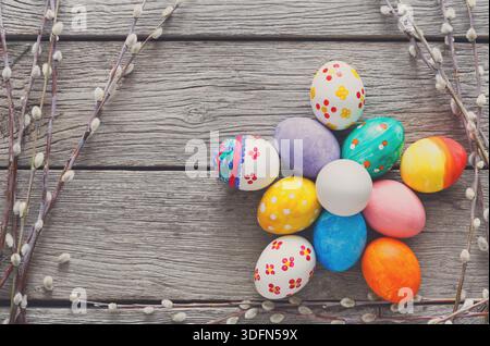 Colorful Decorated Eggs Arranged in a Floral Pattern on a Rustic Wooden Surface Stock Photo