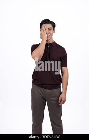 Young Man Touching His Face and Appearing Thoughtful or Surprised Stock Photo