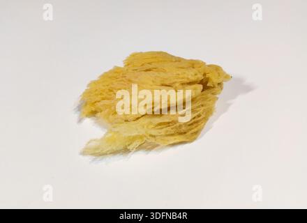 Natural yellow sea sponge isolated on white background. Natural, organic cleaning and bath concept. Natural sea sponge for soft skin care and body hyg Stock Photo