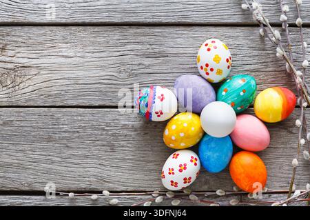 Colorful Decorated Eggs Arranged in a Flower Shape on a Wooden Surface During Spring Season Stock Photo
