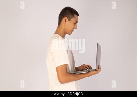 Man using laptop in profile Stock Photo