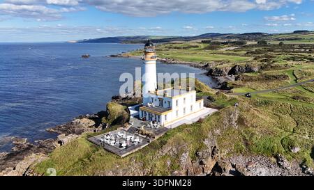Aerial view of Turnberry Lighthouse perched on the rocky coastline overlooking the Firth of Clyde near Turnberry, South Ayrshire, Scotland. Daytime Stock Photo