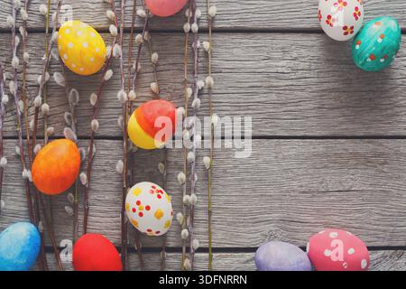 Colorful Easter Eggs and Spring Decorations Arranged on a Rustic Wooden Table Stock Photo