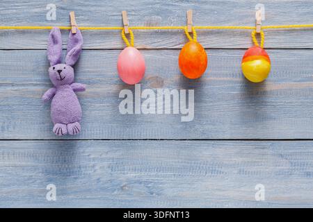 Colorful Easter Decorations With Bunny and Eggs Hanging on a Clothesline Stock Photo
