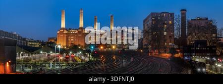 Panorama view of Battersea Power Station from Ebury Bridge Road across railway lines in blue hour Stock Photo