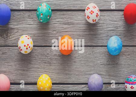 Colorful Decorated Eggs on Wooden Surface for Spring Celebration and Holiday Festivities Stock Photo