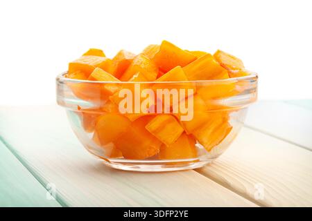 chopped persimmon on wood background on white Stock Photo