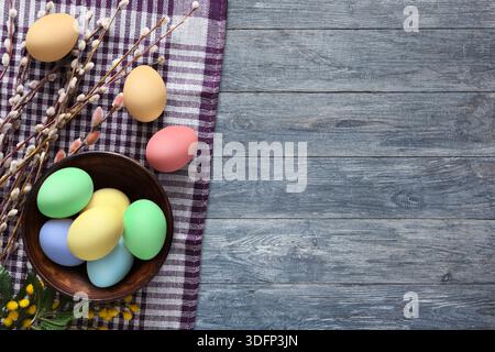 Colorful Easter Eggs Arranged on a Checkered Cloth With Willow Branches Beside Them Stock Photo