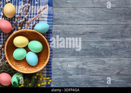 Spring Decorations Featuring Colorful Eggs and Natural Elements on Wooden Surface Stock Photo