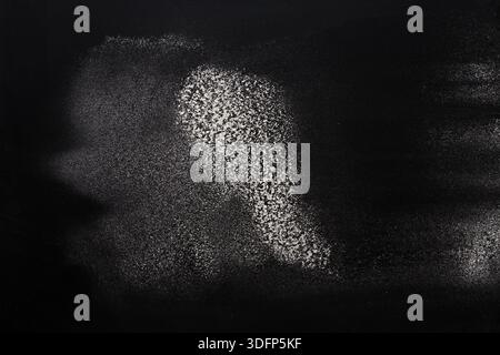 Sprinkled wheat flour splash spots on black background Stock Photo