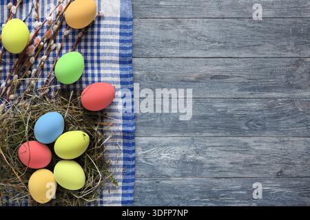 Colorful Easter Eggs Arranged on a Rustic Wooden Surface With Decorative Elements Stock Photo