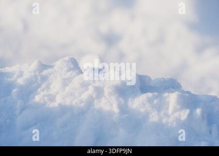 Fresh snow mound in close view with crisp texture and sparkling crystals, soft blurred snowy background and cool tones creating minimalist winter scen Stock Photo