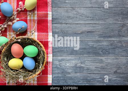 Colorful Easter Eggs Arranged in a Basket on a Red Checkered Tablecloth Stock Photo