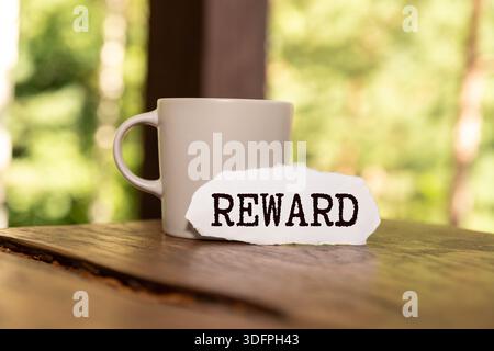 Concept of Rewards Card write on sticky notes isolated on Blue Table. Stock Photo
