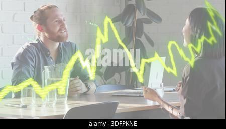 Discussing bearded man and woman in business attire reviewing laptop in modern office neon overlay Stock Photo