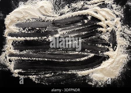 Flour Dust Creating Patterns on a Dark Surface During Baking Activity in a Kitchen Stock Photo