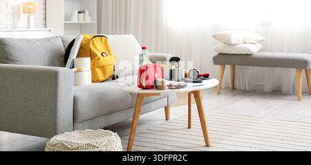 Emergency backpack with necessities on table in living room Stock Photo