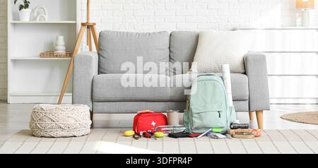 Emergency backpack with necessities on carpet in living room Stock Photo