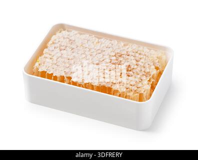 Fresh Organic Honeycomb Slab in a White Plastic Container Isolated on White Background Stock Photo