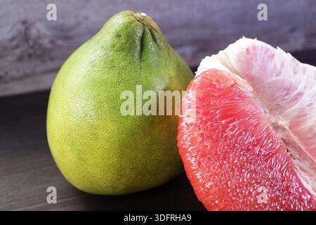 Delectable Peeled Bright Red Pomelo Fruit with the Whole Fruit Stock Photo