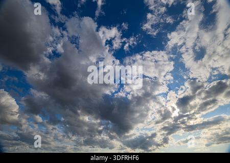 A breathtaking and stunning view of the vibrant dynamic cloudscape set against a wonderfully clear blue sky Stock Photo
