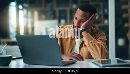 Black man, laptop and tired with remote work from home, frustrated and stress with copywriting. African person, computer and exhausted with burnout Stock Photo
