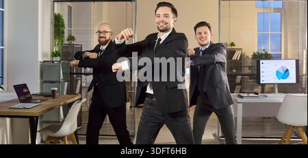 Managers dancing in modern office, celebrating success, teamwork and motivation Stock Photo