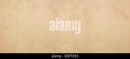 Beige plaster wall showing a rough and abstract textured surface Stock Photo