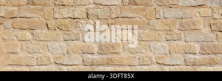 Sandstone wall surface with beige blocks and visible mortar joints Stock Photo