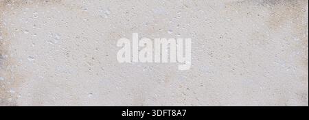 Rough limestone texture covering a weathered cement wall surface, creating a subtle background Stock Photo