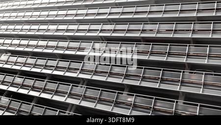 Urban building facade with repetitive horizontal lines and geometric structure Stock Photo