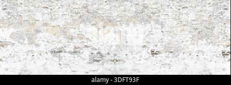 Old white painted plaster wall displaying a distressed and grunge texture background Stock Photo
