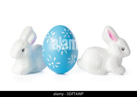 Plastic bunnies and blue egg decorate a table for Easter celebration in spring season Stock Photo