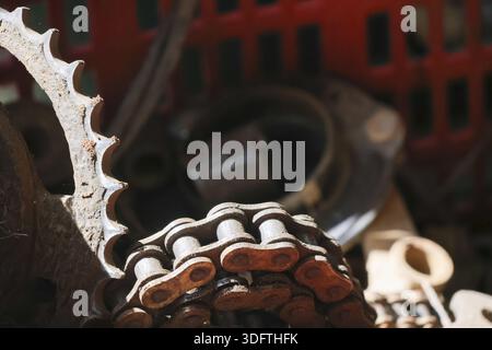 Old rusty steel chain and sprocket gear macro shot showing rough texture of worn metal part with nostalgic feeling of industrial waste and mechanical Stock Photo