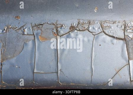 Cracked peeling paint texture on old rusty metal background with worn distressed surface pattern showing grunge decay and weathered detail abstract de Stock Photo