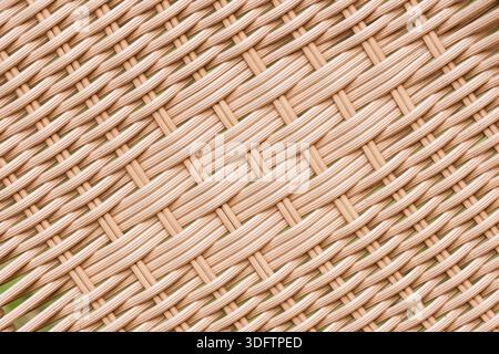Close up view of brown plastic rattan texture with calm and simple feeling creating neat abstract pattern background for design and decoration Stock Photo