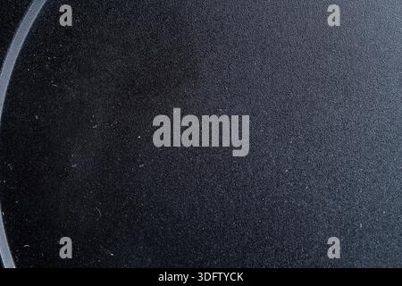High detailed macro of dark black matte surface. Professional plastic or metal texture with subtle grain and dust for minimalist design background. Stock Photo