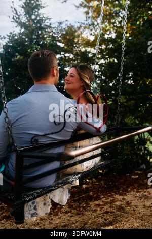 Romantic couple swing in the autumn park Stock Photo - Alamy
