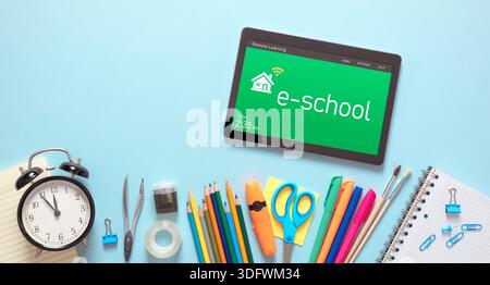Remote learning, e-learning concept. Tablet with remote learning system, school supplies Stock Photo
