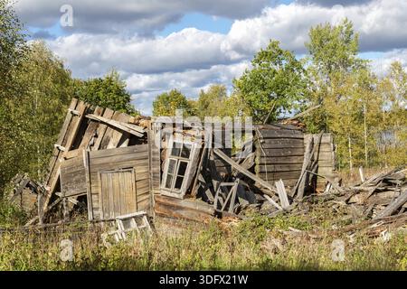 Old wooden broken houses in russian abandoned village in summer day Stock Photo