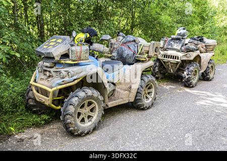 Novgorod region, Russia - August 8, 2020: Off-roader quad bikes after driving on extremely dirty rural road Stock Photo