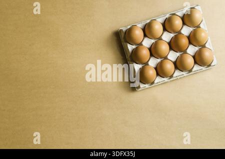 Beautiful fresh brown chicken eggs on brown background with copy space Stock Photo