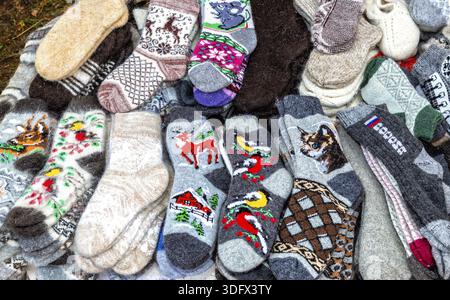Warm winter wool knitted socks of different sizes and colors. Handmade wool socks. Waiting for the winter Stock Photo