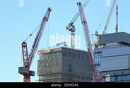 SYMBOL - 12 December 2025, Berlin: At Alexanderplatz, several construction cranes stand around the shell of a high-rise building. Photo: Elisa Schu/ Stock Photo